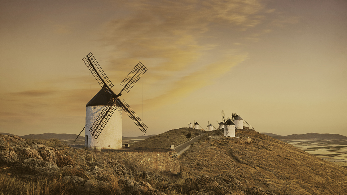 Eine hügelige Landschaft mit mehreren Windmühlen